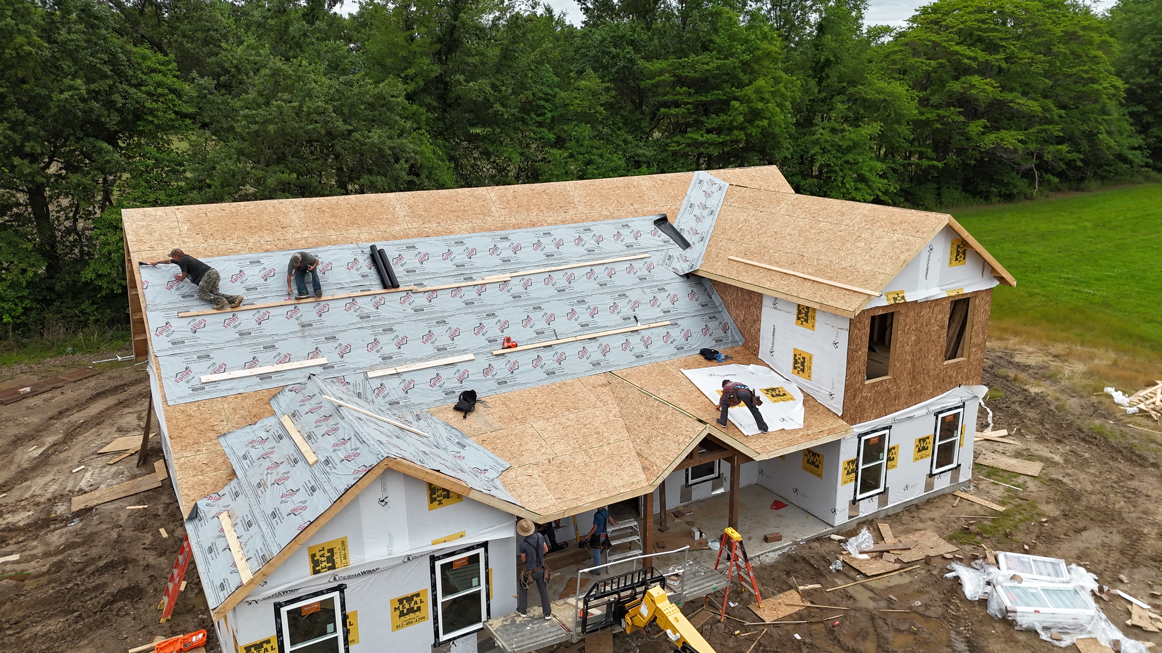 SID Roofing team at work on a residential roof